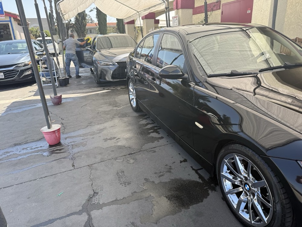 A BMW and Lexus getting the hand-wash treatment